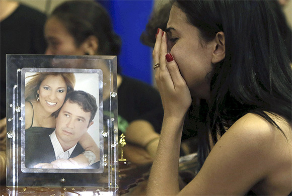 A relative of victims of the fire at Boate Kiss nightclub attends a collective wake in Santa Maria