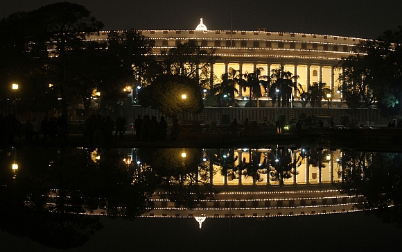 The Parliament building is illuminated during the ceremony in New Delhi