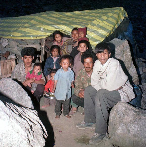 A family takes refuge in a makeshift tent on the outskirts of Kargil, May 26, 1999.