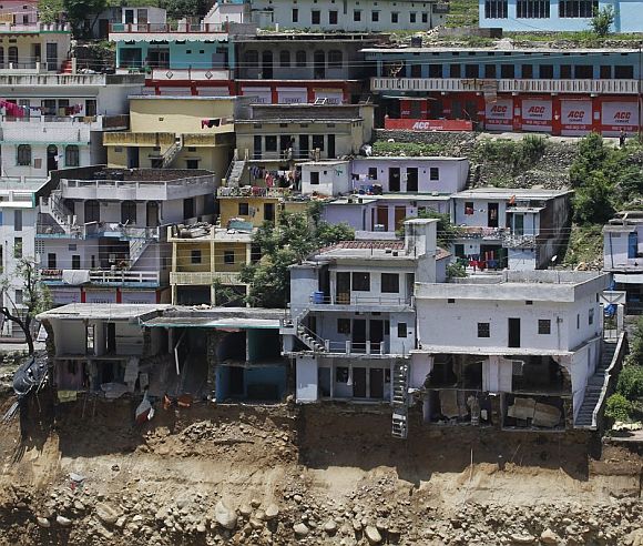 Buildings destroyed during floods are seen next to the Alaknanda river in Govindghat