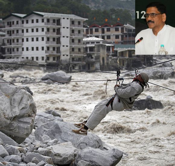 A man is pulled across to safety on a rope, as damaged buildings and the Alaknanda river are seen in the background, during a rescue operation in Govindghat in Uttarakhand (Inset) M Shashidhar Reddy