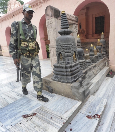 A security personnel walks next to bloody footprints inside the Mahabodhi temple complex 