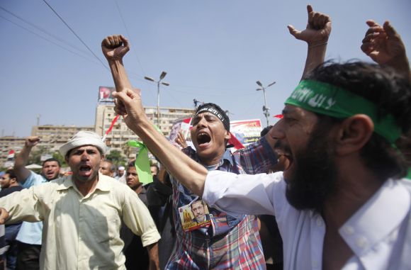 Members of Muslim Brotherhood shout slogans against army after clashes near Republican Guard headquarters
