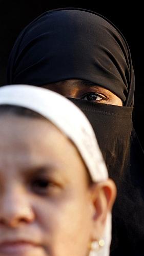 A women listens to a speaker during a rally in Mumbai