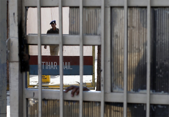 A policeman walks inside the Tihar Jail in New Delhi, where the main accused in the Delhi gang-rape hanged himself 