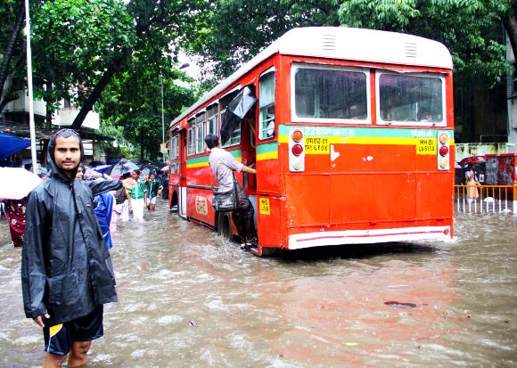 A BEST bus wades through waterlogged roads near the Sion railway station in Central Mumbai on Friday