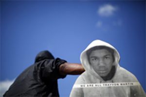 A man holding a cardboard cut out of Trayvon Martin protests the acquittal of George Zimmerman.