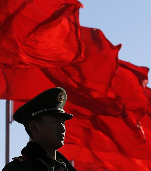 A paramilitary policeman stands guard at Tiananmen Square near the Great Hall of the People in Beijing