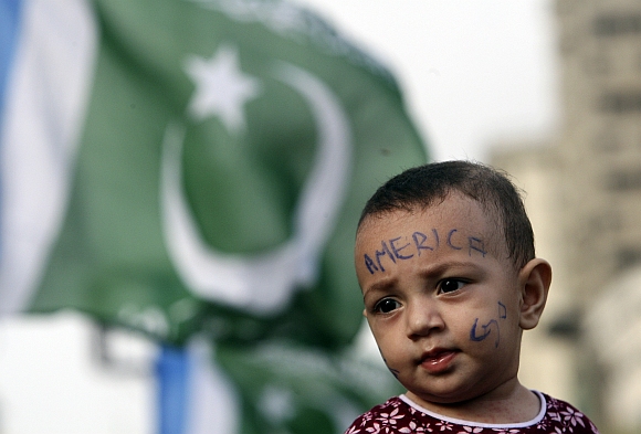 A child's face is seen painted with the words, 'America Go' during an anti-American demonstration in Karachi