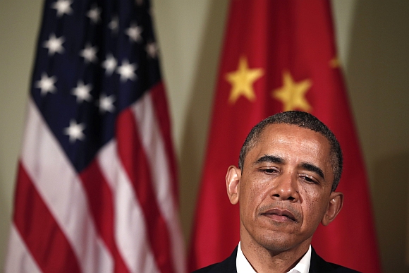 US President Barack Obama listens to a response from Chinese President Xi Jinping
