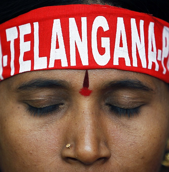 A pro-Telangana supporter listens to a speaker during a protest in New Delhi 