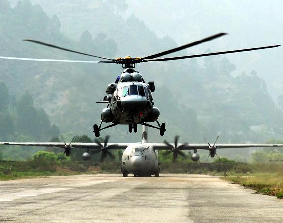 A Mi-17 V5 helicopter and C 130J at Dharasu airfield in Uttarakhand. Men and machine worked through the night to get the runway ready for the giant C 130J to land with fuel supply for day 1 of ops.