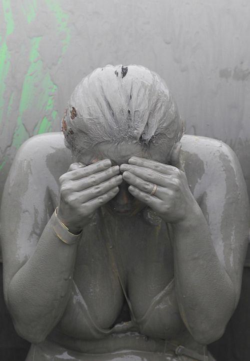 A woman plays in mud during the Boryeong Mud Festival at Daecheon beach in Boryeong, about 190 km southwest of Seoul