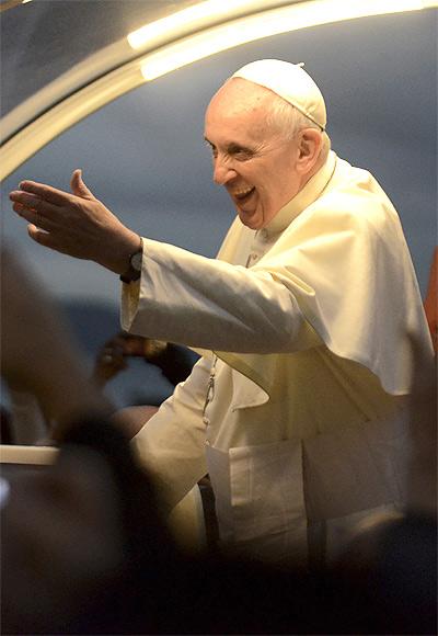 Pope Francis greets faithful as he is driven along the beachfront in the Copacabana neighborhood of Rio de Janeiro