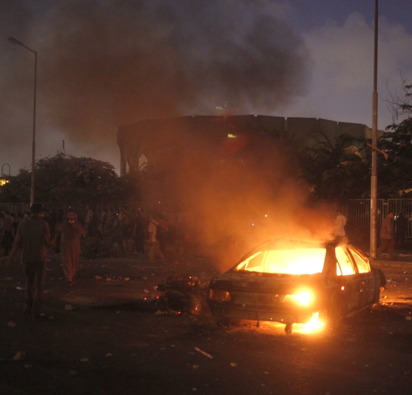 A car that members of the Muslim Brotherhood and supporters of deposed Egyptian President Mohamed Morsi say was burnt by police and plain-clothed people is seen during clashes in Nasr city area, east of Cairo