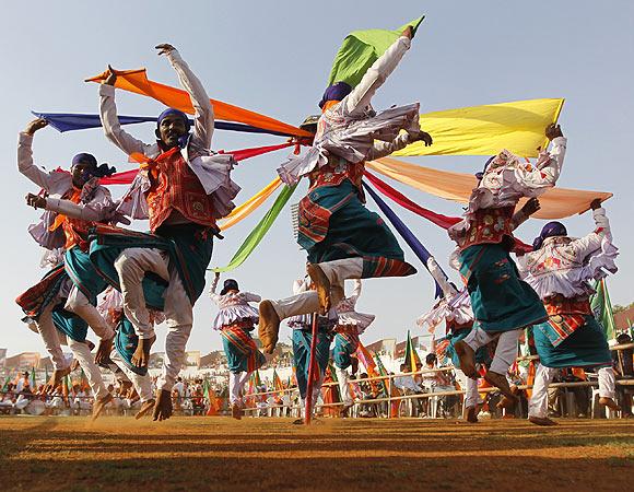 Supporters of BJP perform a folk dance at a rally