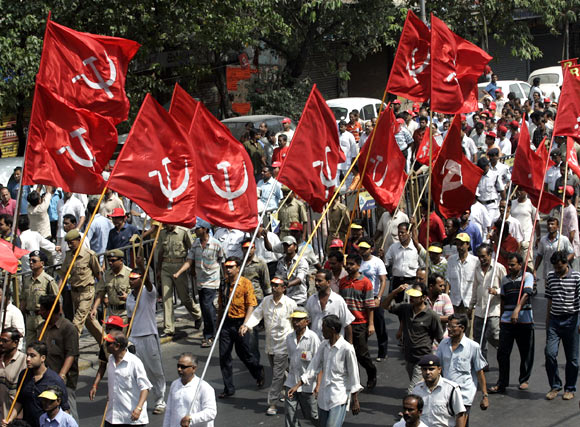 Activists of the CPI-M march during an election campaign rally