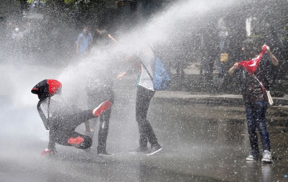 Police use a water cannon against protesters during a demonstration in Ankara
