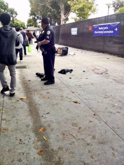 A policeman stands guard over the scene where a man believed to be the suspect in a shooting incident at Santa Monica College was shot.