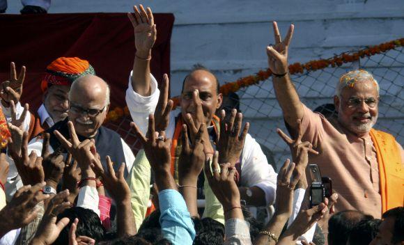 BJP president Rajnath Singh with Gujarat Chief Minister Narendra Modi and senior leader L K Advani