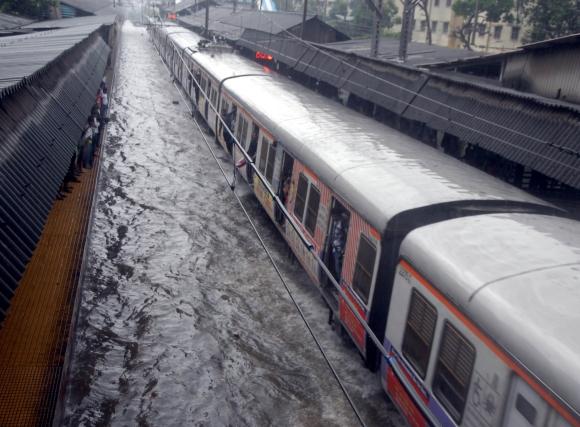 Tracks are submerged underwater at Sion station in Mumbai