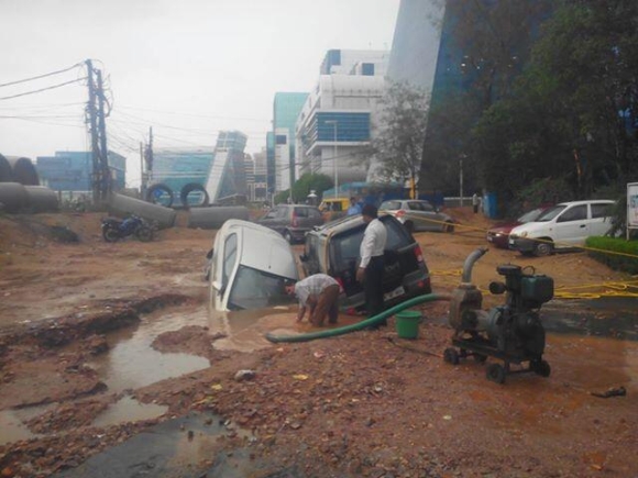 Cars fall into a pothole in Delhi following the heavy rains