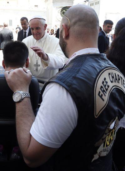 Pope Francis blesses a sick boy who is accompanied by a Harley-Davidson biker after Mass in Saint Peter's Square at the Vatican