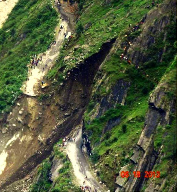 This image shows one of the many roads in Uttarakhand that were destroyed in the landslide. People can be seen taking a hike on the hills to reach the other end of the road