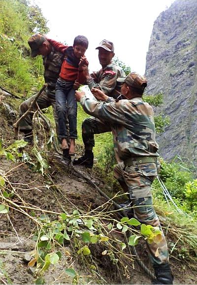 Indian Army personnel rescuing stranded people in rain-ravaged and landslide-hit Uttarakhand on Wednesday