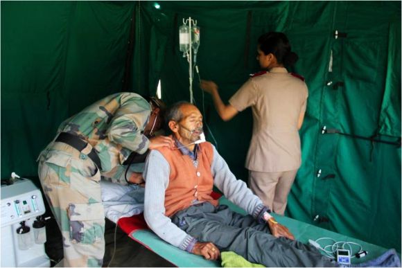 Army personnel providing medical aid to rescued people in flood-hit Uttarakhand on Thursday