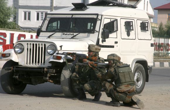 Army personnel taking positions after a militant strike outside Srinagar