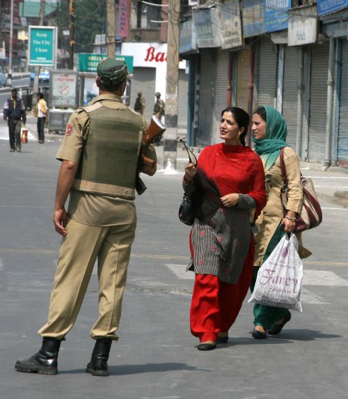J&K Police personnel question women as during stringent restrictions in Srinagar on Tuesday