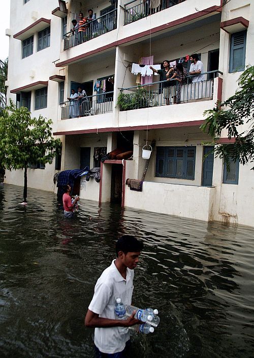  Volunteers supplying water bottles to residents stuck in a water logged society in Mumbai during the infamous July 26, 2005, floods