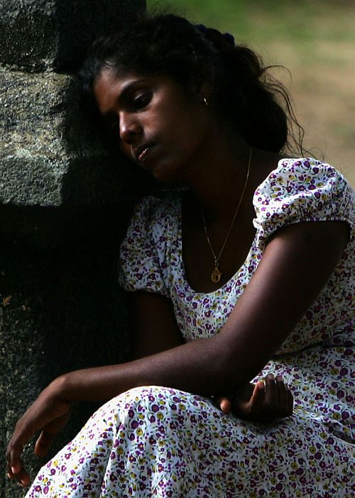 A homeless woman rests at a regugee camp in Chennai