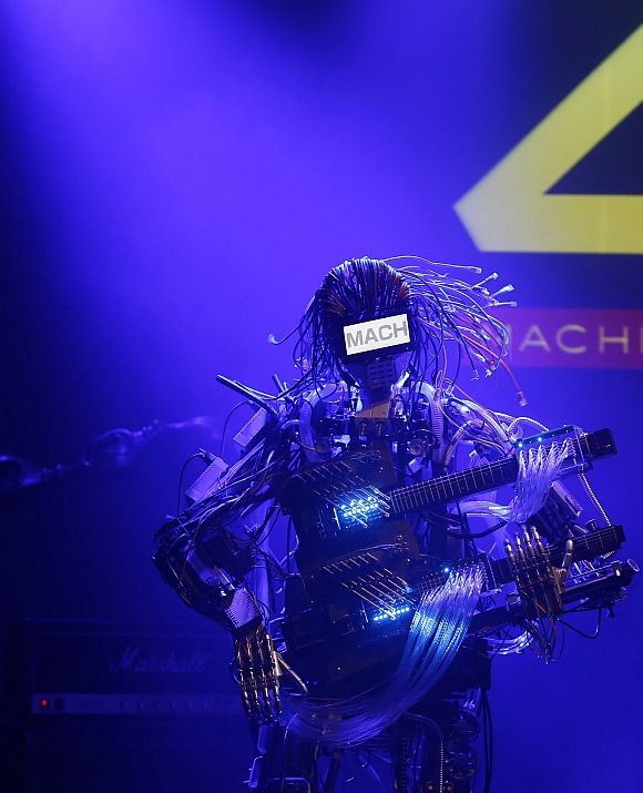 A member of the robot rock band Z-Machines, guitarist Mach, performs during the band's debut live concert in Tokyo