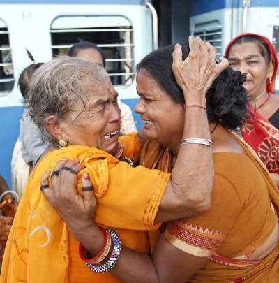 A pilgrim who was stranded in Uttarakhand reacts after meeting her relatives at a railway station  Ahmedabad