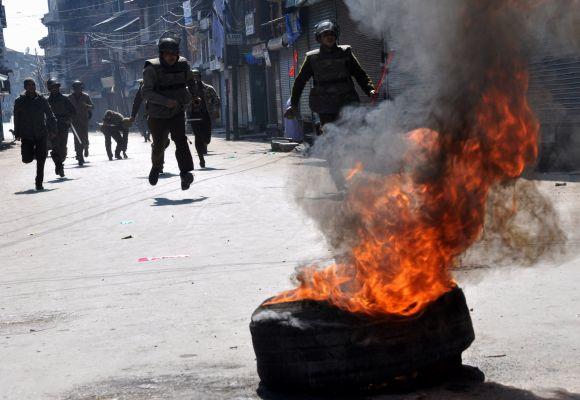 Security personnel seen chasing protestors who tried to defy curfew restrictions in Srinagar on Wednesday