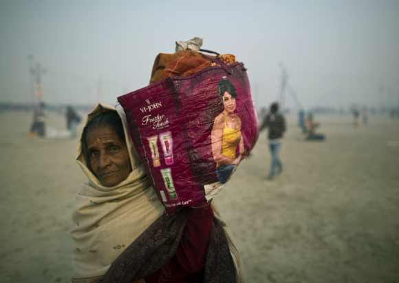 A pilgrim prepares to leave the Kumbh Mela on the last day of the congregation