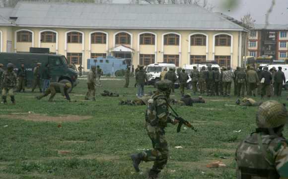 Security personnel take cover during a ecounter with terrorists