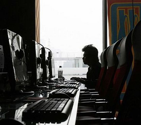 A person works on his computer at a cyber caf  in China (image for representational purpose only)