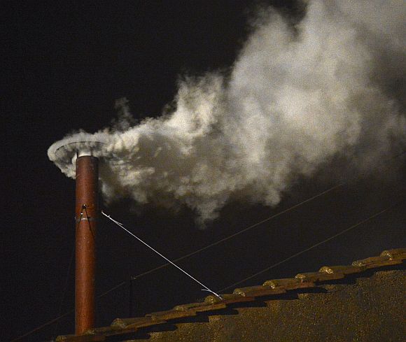 White smoke billows out of the chimney over the Sistine Chapel, announcing the election of the new Pope
