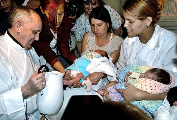 File photo of Argentine Cardinal Bergoglio washing the feet of two newly born children on Holy Thursday at the Buenos Aires' Sarda maternity hospital on March 24, 2005