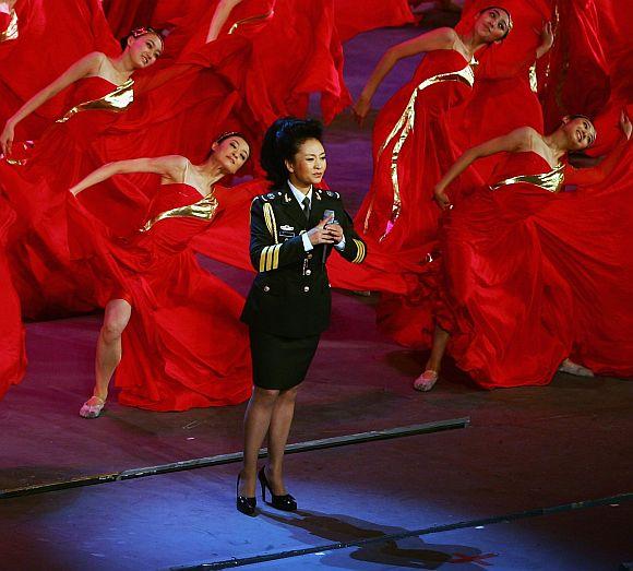 Vocalist Peng Liyuan, wife of Xi Jinping of the Central Secretariat of the Communist Party of China, sings army's song during the 'Red Army Flag' theatrical evening at the Great Hall of the People on July 30, 2007 in Beijing