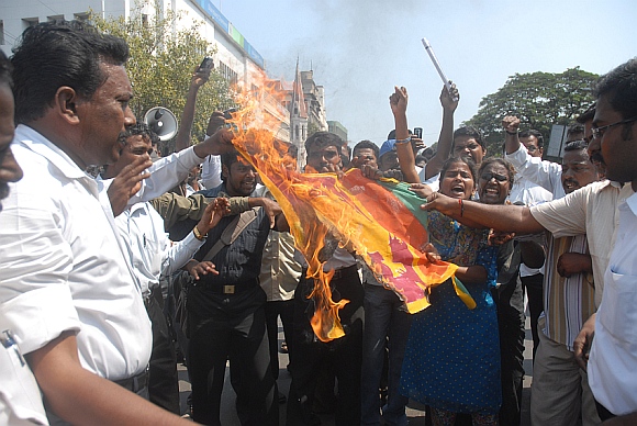 Protesters burn a Sri Lankan flag during a strike in Chennai
