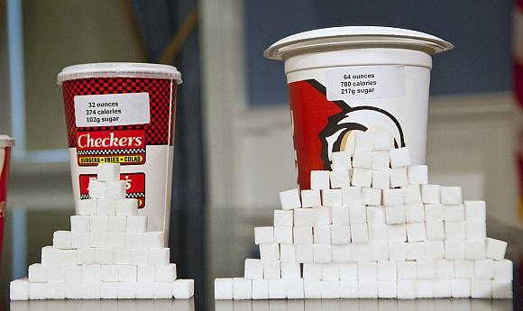 Soft drink cups sized (left to right) at 32 ounces and 64 ounces are displayed at a news conference at City Hall in New York. Under a new law proposed by New York City Mayor Michael Bloomberg, all soft drinks over 16 ounces will be banned in restaurants and stores that fall under the jurisdiction of New York City