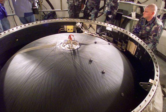 US Air Force missile maintenance technicians look over the top of a Peacekeeper nuclear missile, that were being dismantled, deep in an underground silo on the Wyoming prairie.