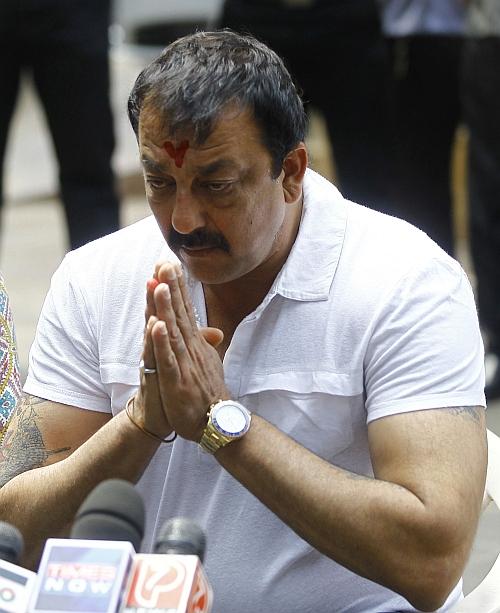 Bollywood actor Sanjay Dutt gestures during a news conference outside his residence in Mumbai