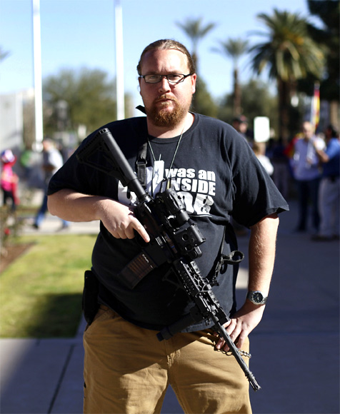 Brandon Smith poses with his AR-15 rifle during a pro-gun and Second Amendment protest outside the Arizona State Capitol in Phoenix, Arizona