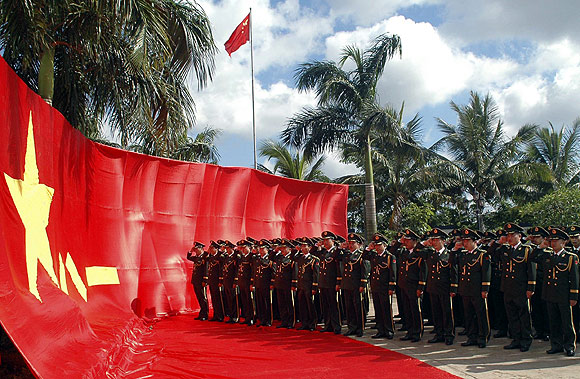Frontier guards, dressed in the latest upgrade uniform, take an oath in front of the Chinese army flag in Wenchang, south China's Hainan province