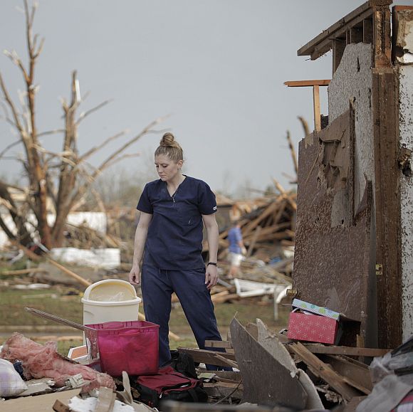 Dana Ulepich looks at the debris from her house destroyed by a powerful tornado ripped through the area in Moore, Oklahoma